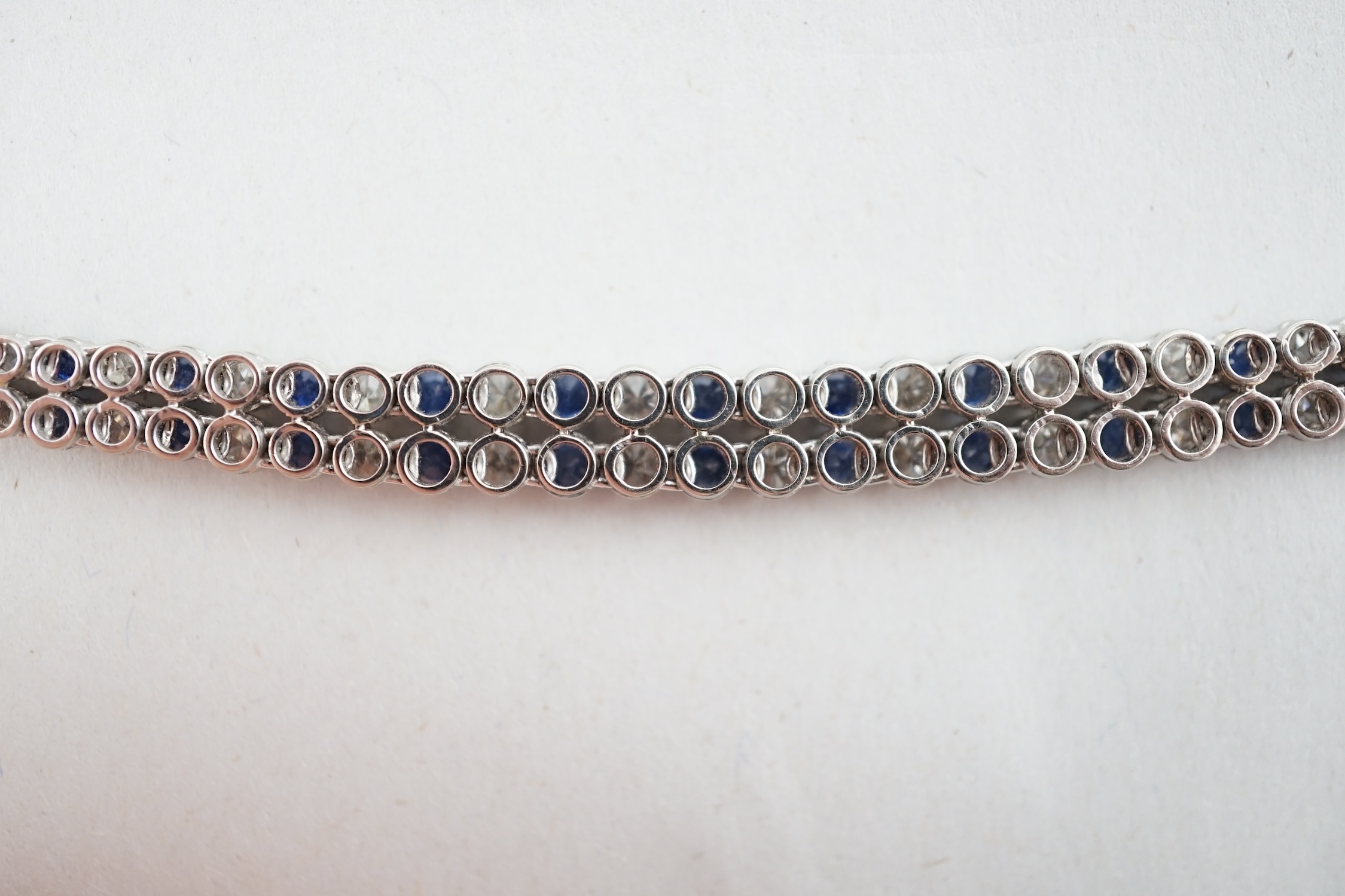 A 1960's 14ct white gold, sapphire and diamond two row line bracelet